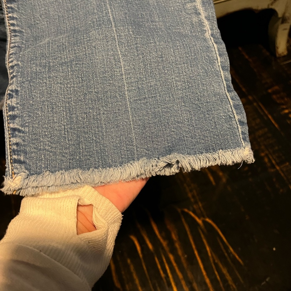 Woman’s flare ankle length Old Navy jeans.